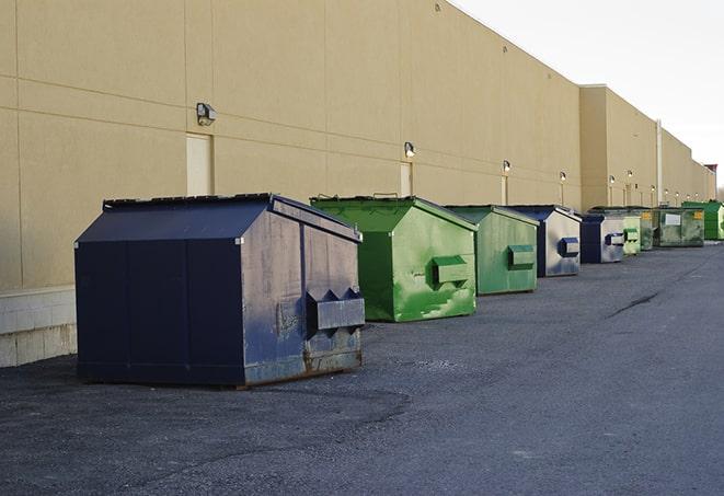 a row of heavy-duty dumpsters ready for use at a construction project in Branford, FL